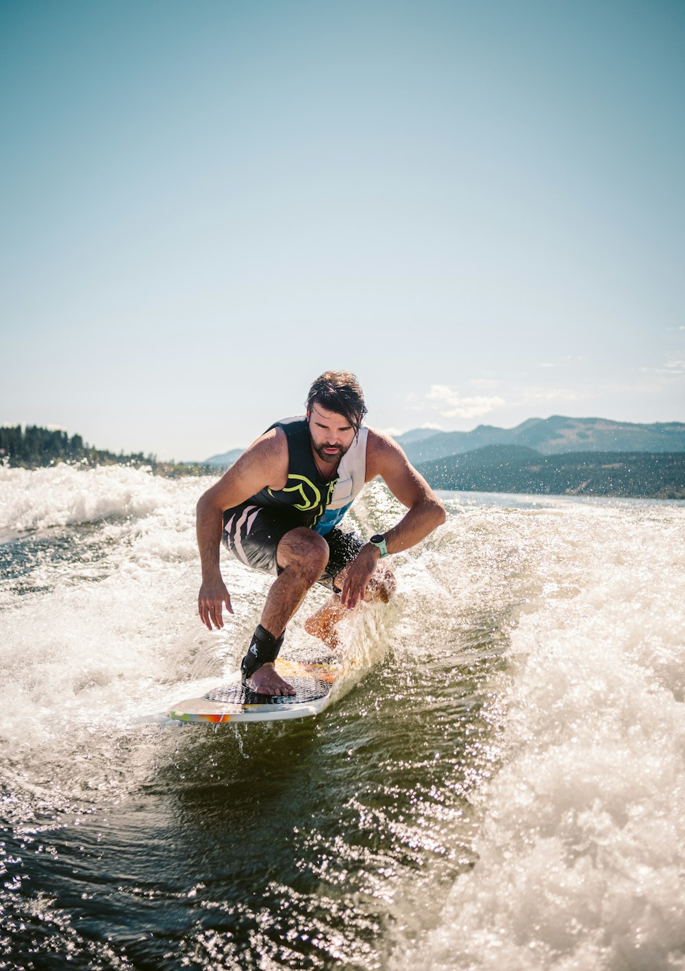 a man riding a wave on a surfboard in the water