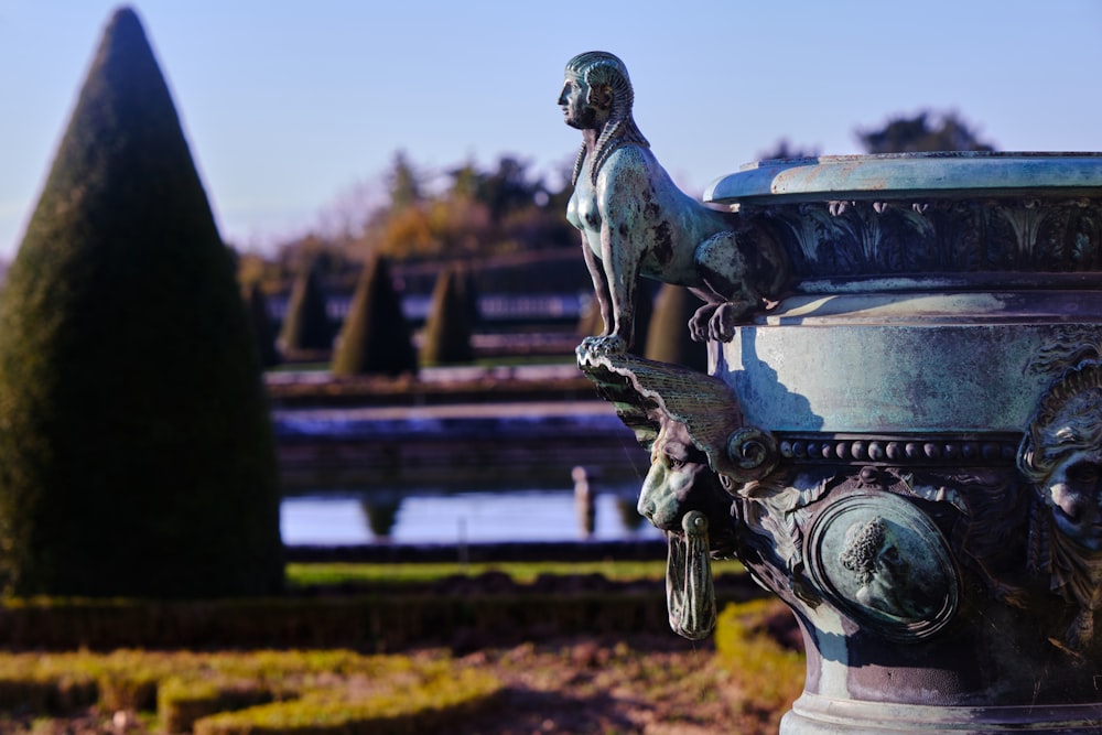 a statue of a man on a pedestal in a garden