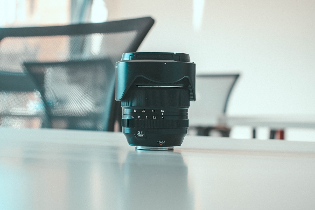a camera lens sitting on top of a table, Fujifilm XF zoom Lens 16-80 F4