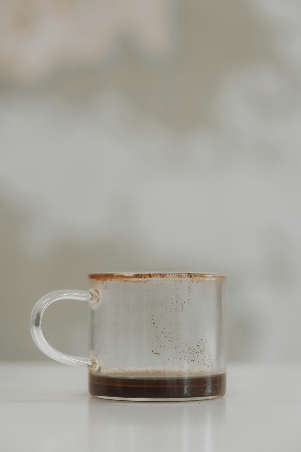 a white and brown coffee cup sitting on top of a table