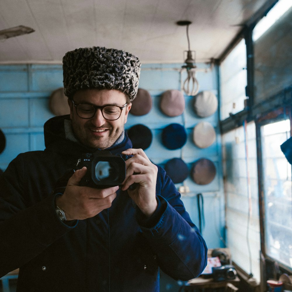 a man taking a picture of himself in a hat