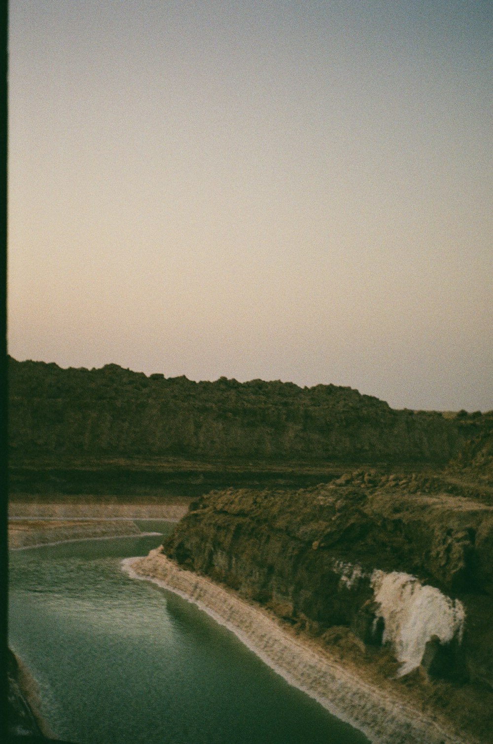 a large body of water near a mountain