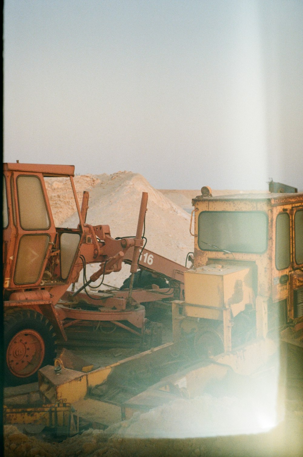 a large pile of dirt sitting next to a pile of trucks