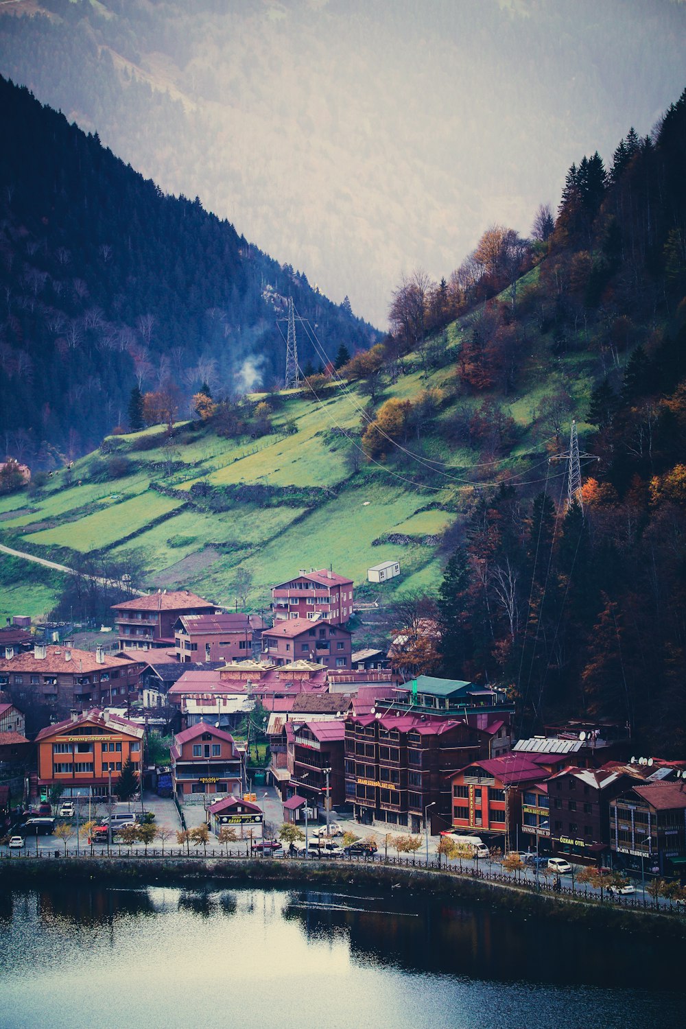 a town on a hillside with a body of water in front of it