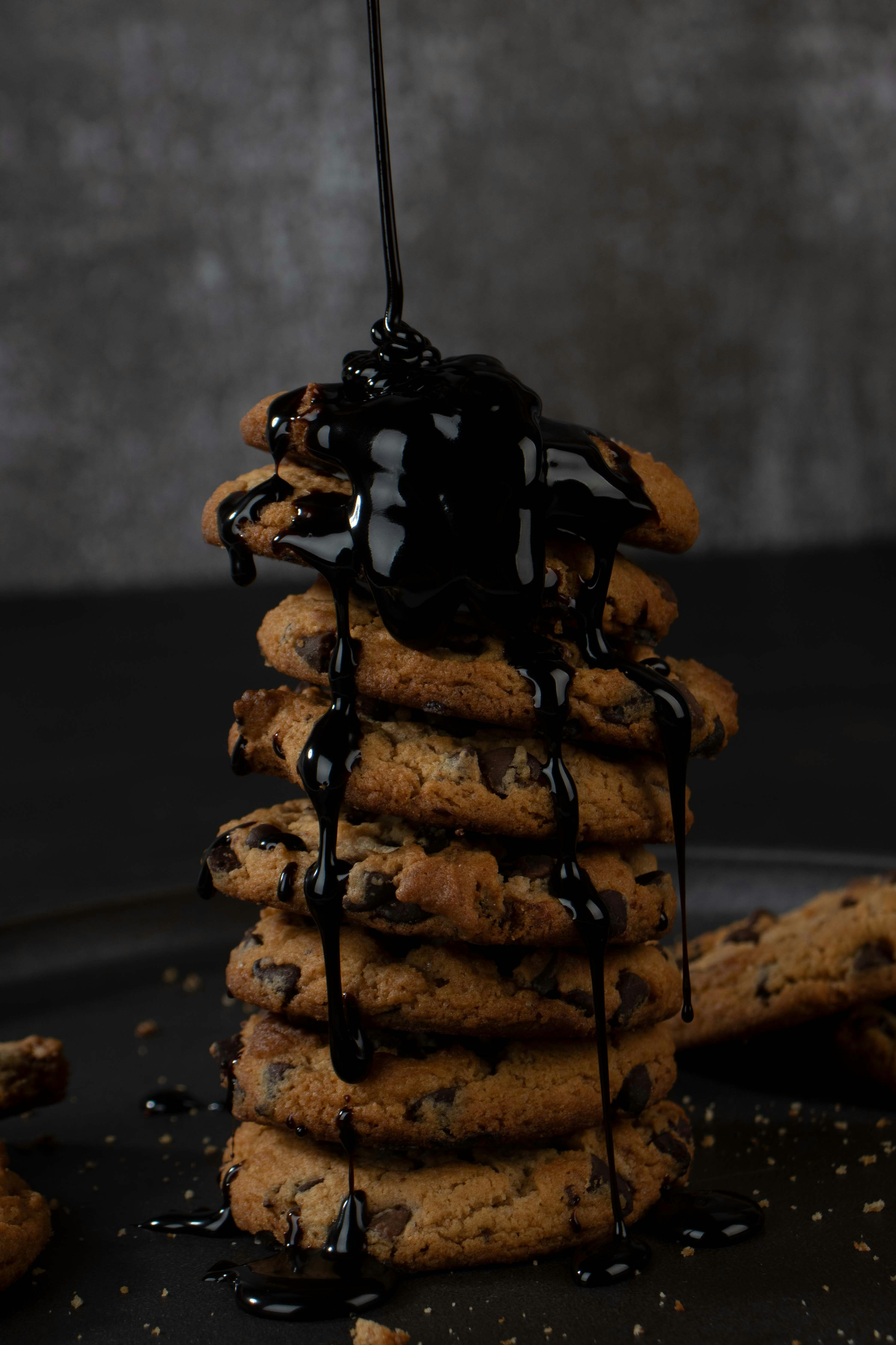 a stack of cookies covered in chocolate syrup