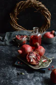 pomegranates and a bottle of wine on a table
