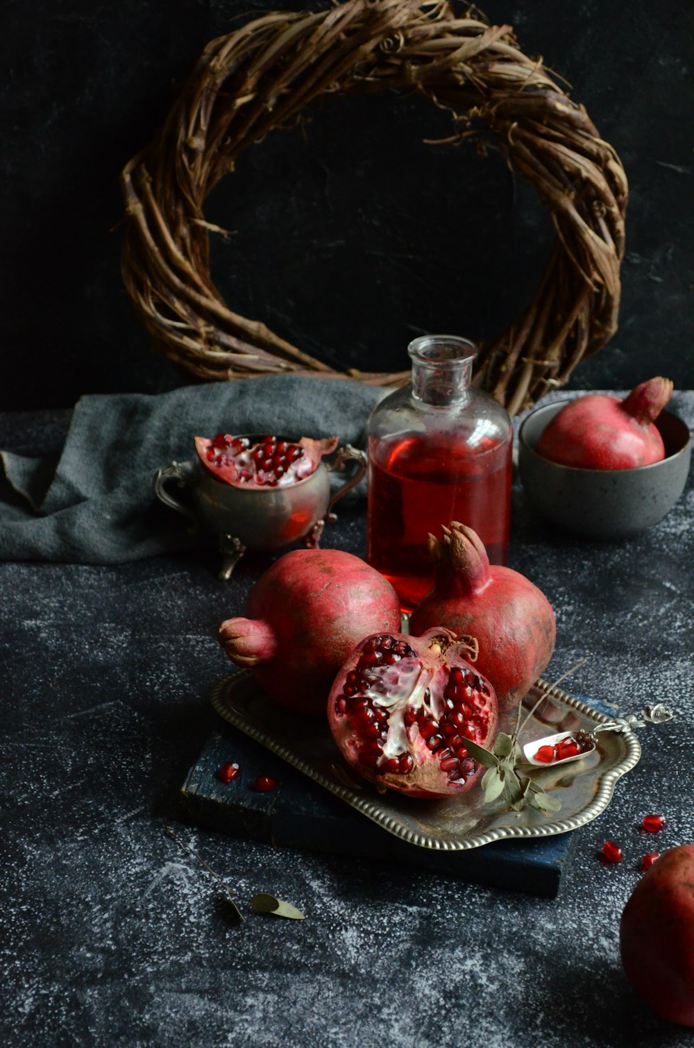 pomegranates and a bottle of wine on a table