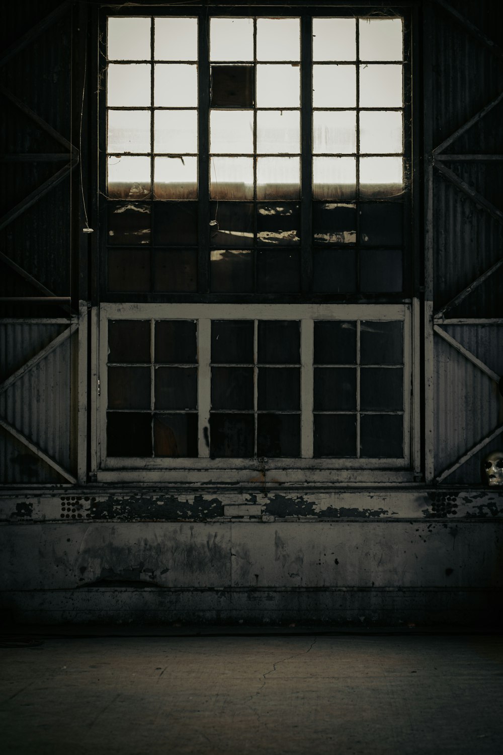 an empty room with a window and bars