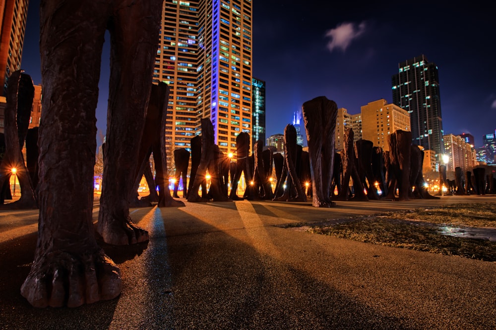 a statue of a person standing in front of a city