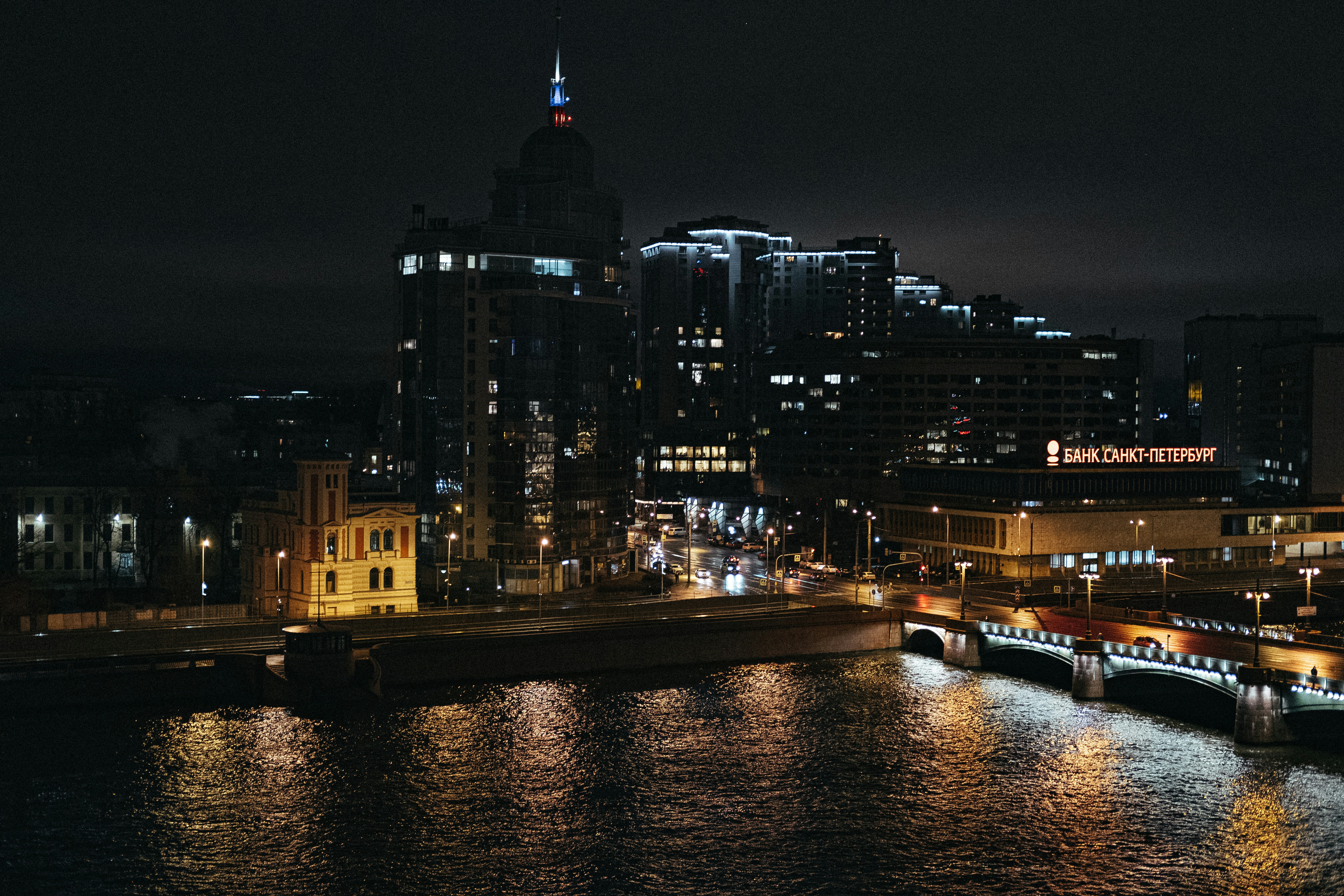 a night view of a city with a river running through it