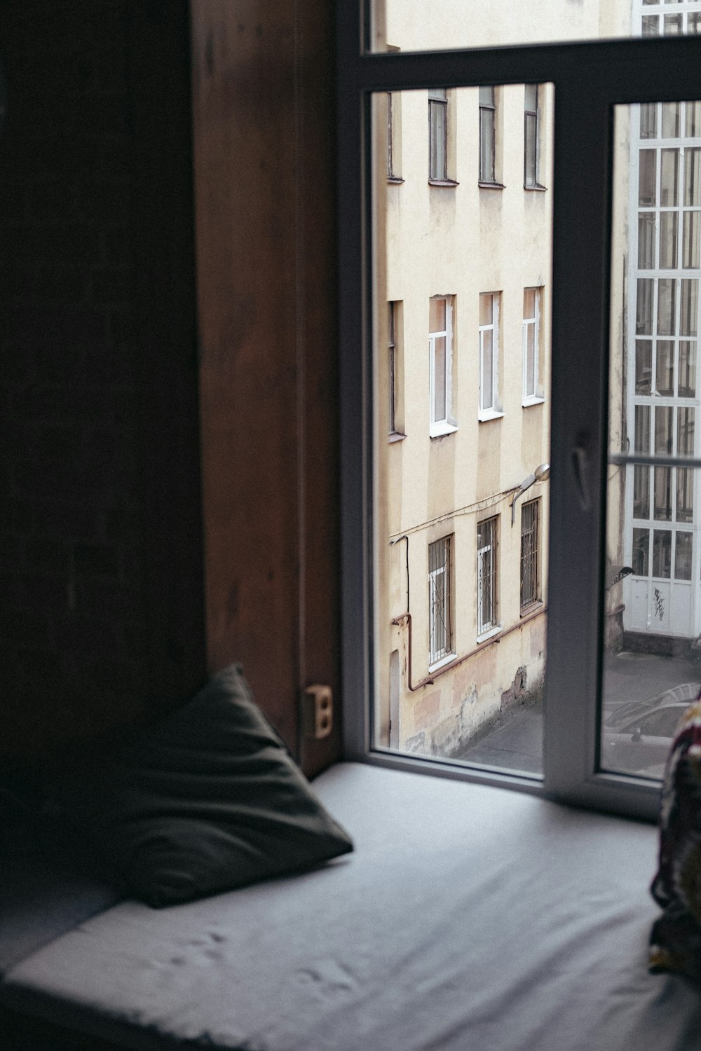 a bed sitting in a bedroom next to a window