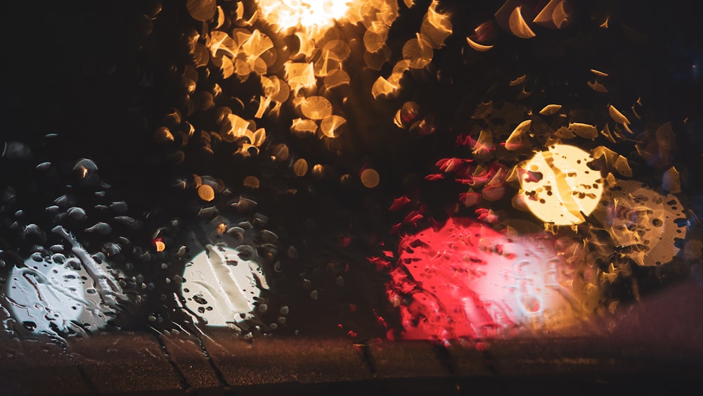 a close up of a rain covered window at night