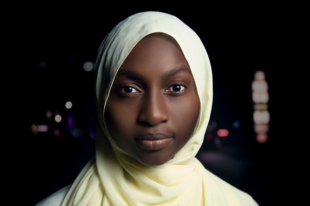 a woman in a yellow hijab looks at the camera