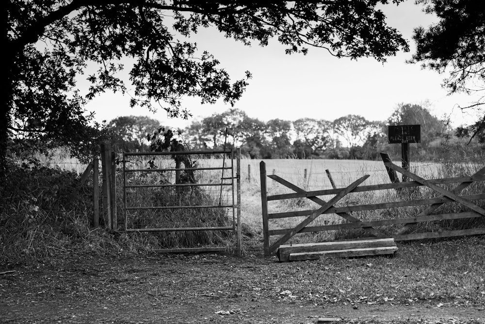 a black and white photo of a wooden gate