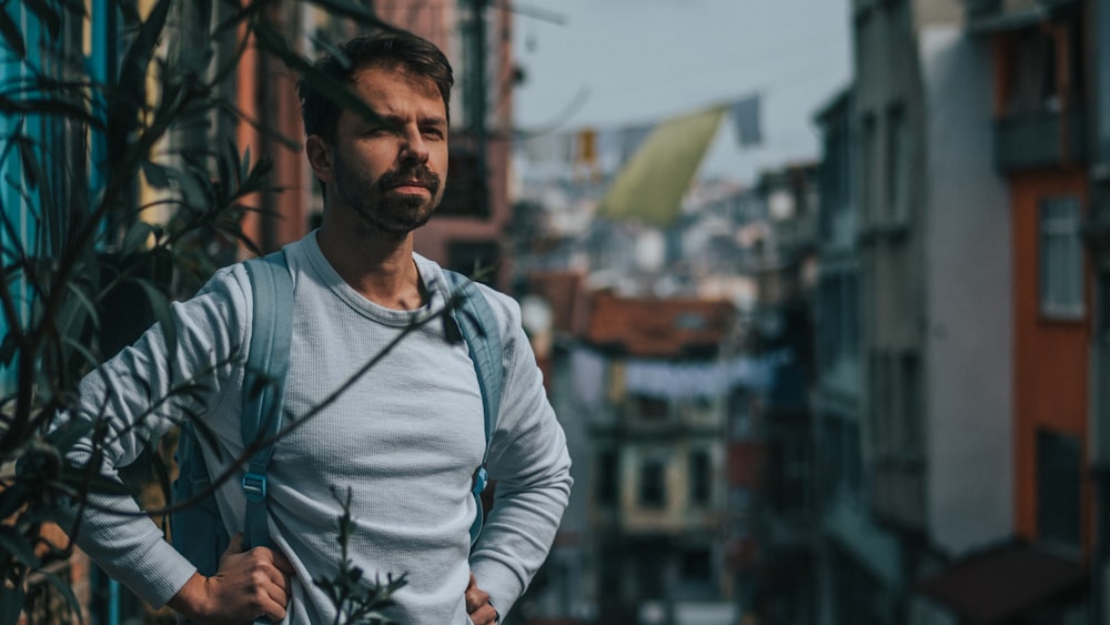 a man standing in front of a building in a city