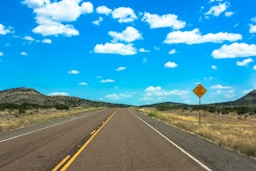 a yellow sign sitting on the side of a road