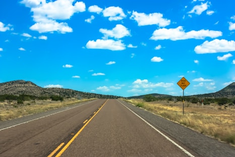 a yellow sign sitting on the side of a road