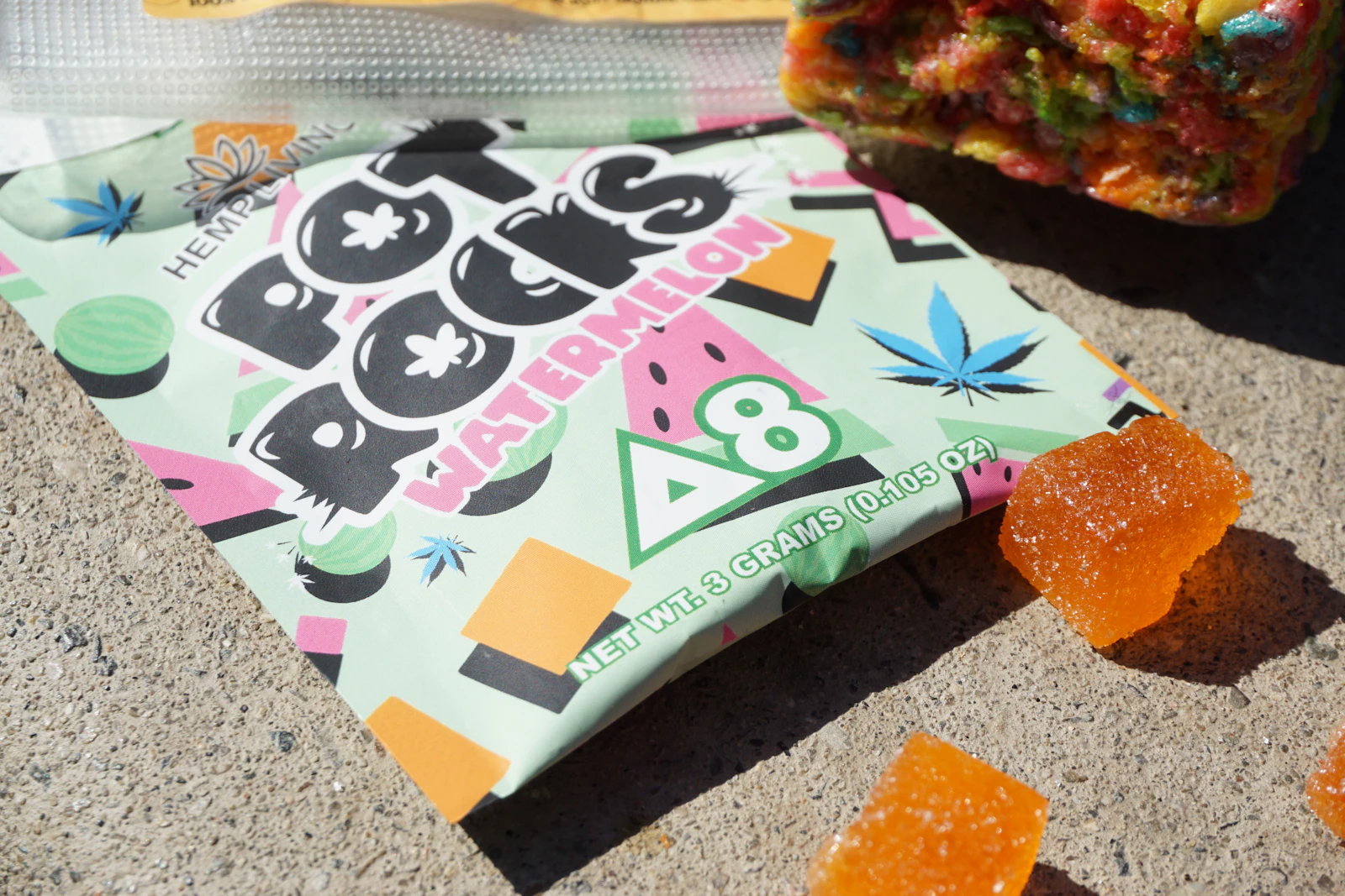 Labeled THC gummy package with individual cannabis infused gummies portioned into measured servings