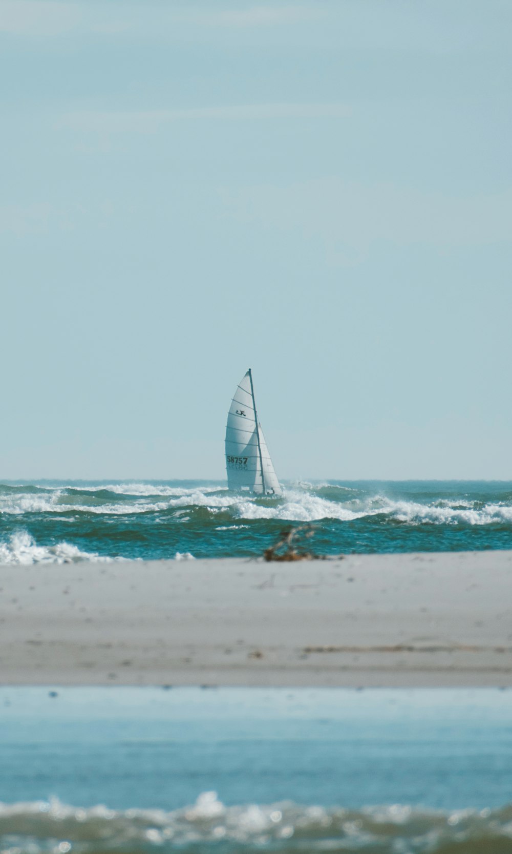 a sailboat in the ocean on a sunny day