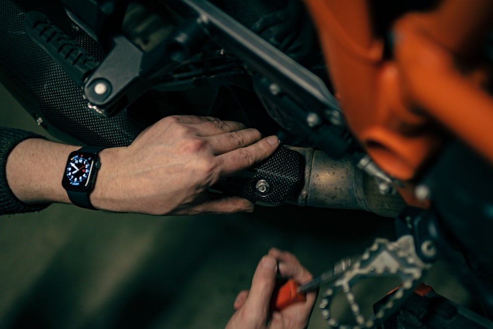 a close up of a person working on a motorcycle