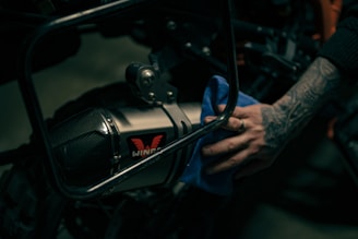 a close up of a person's hand on a motorcycle