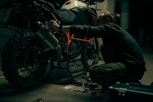 a man working on a motorcycle in a garage