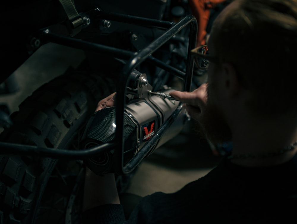 a man is working on a motorcycle engine