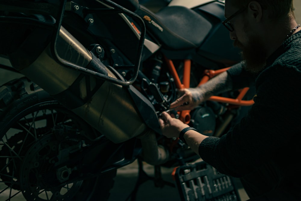 a man working on a motorcycle in a garage