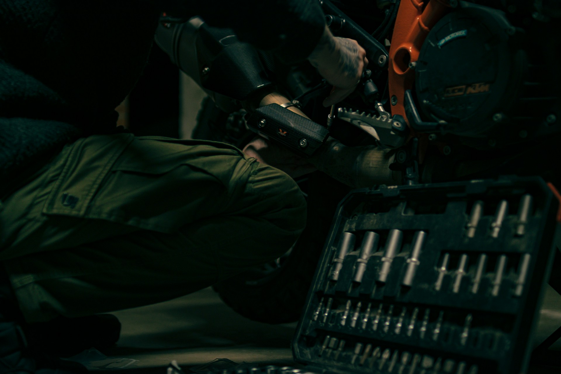 a man working on a motorcycle in a garage