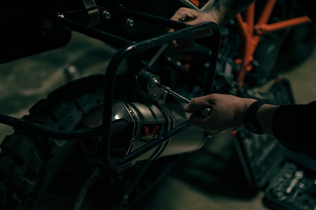 a close up of a person working on a motorcycle