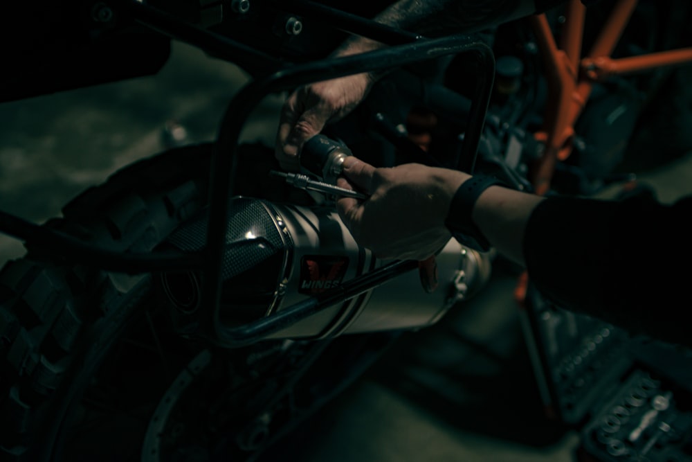 a close up of a person working on a motorcycle