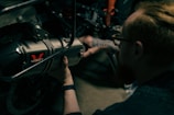a man working on a motorcycle with a wrench