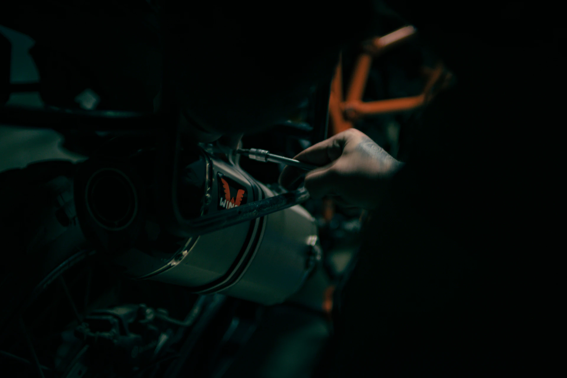 a close up of a person working on a motorcycle