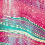 Vivid abstract artwork featuring flowing, wave-like patterns with a mix of pink, teal, and gold hues. The composition has a textured appearance, resembling brush strokes or layered paint.