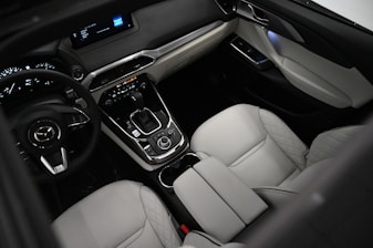 the interior of a car with a steering wheel and dashboard