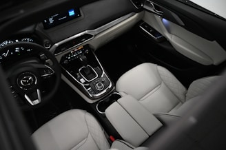 the interior of a car with a steering wheel and dashboard