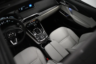 the interior of a car with a steering wheel and dashboard