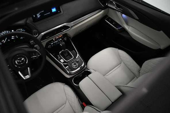 the interior of a car with a steering wheel and dashboard