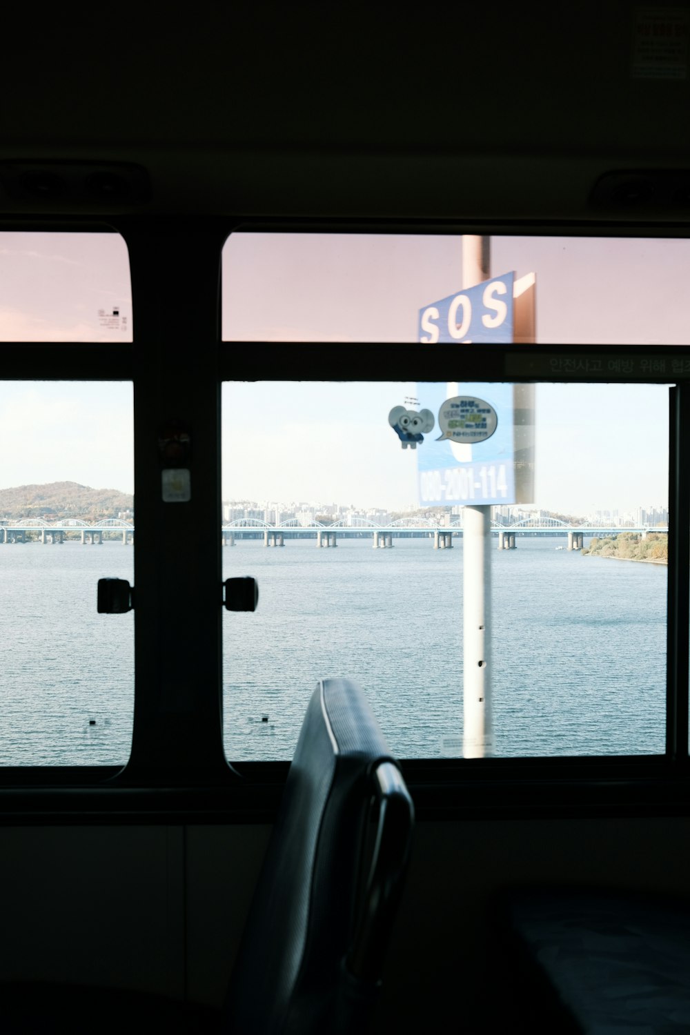 a view of a body of water from inside a bus