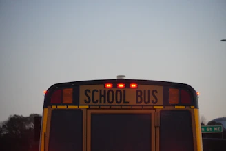 the back of a school bus with its lights on