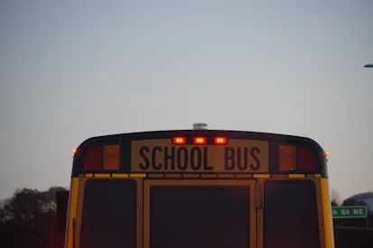 the back of a school bus with its lights on