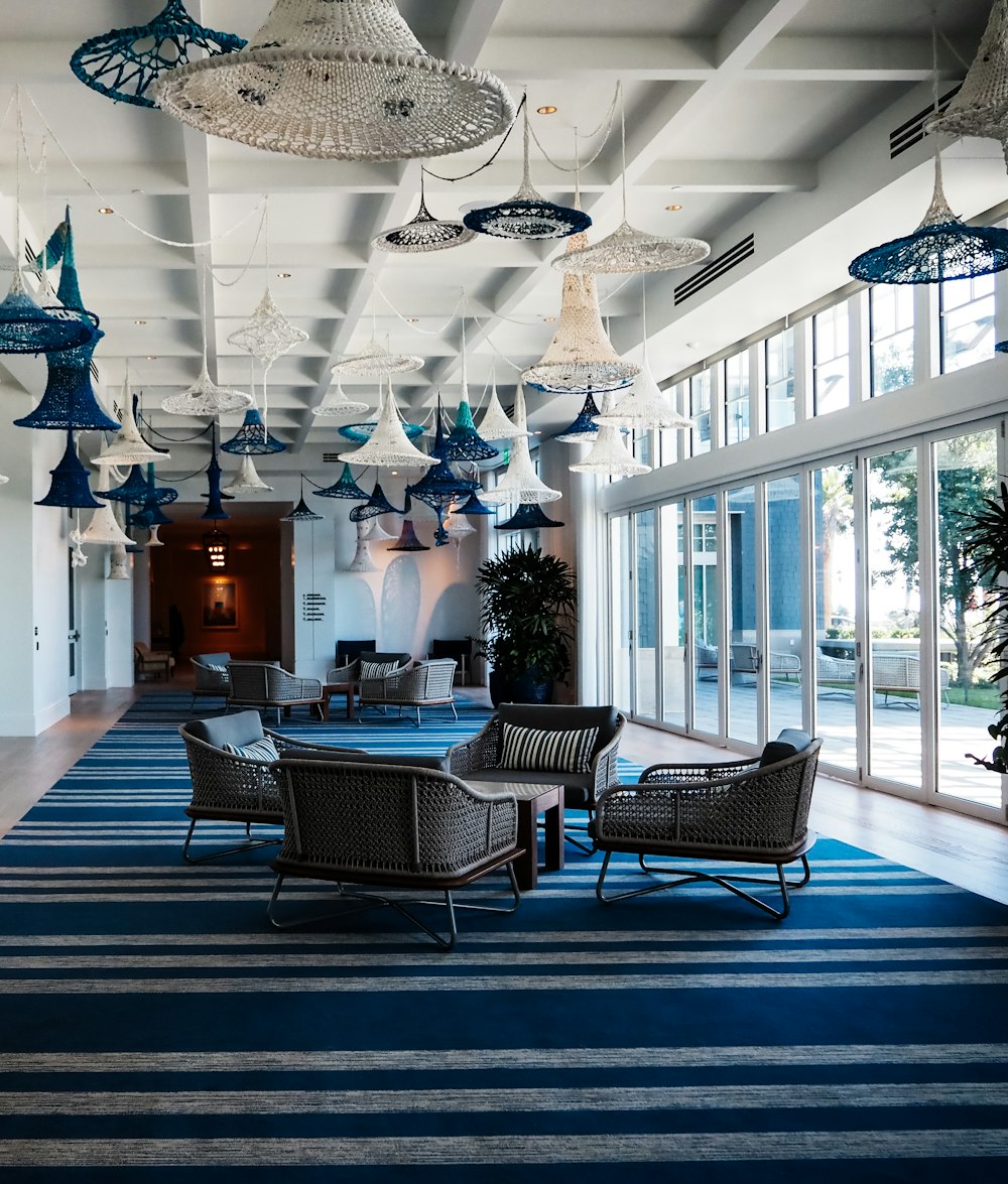 a large room with chairs and lamps hanging from the ceiling