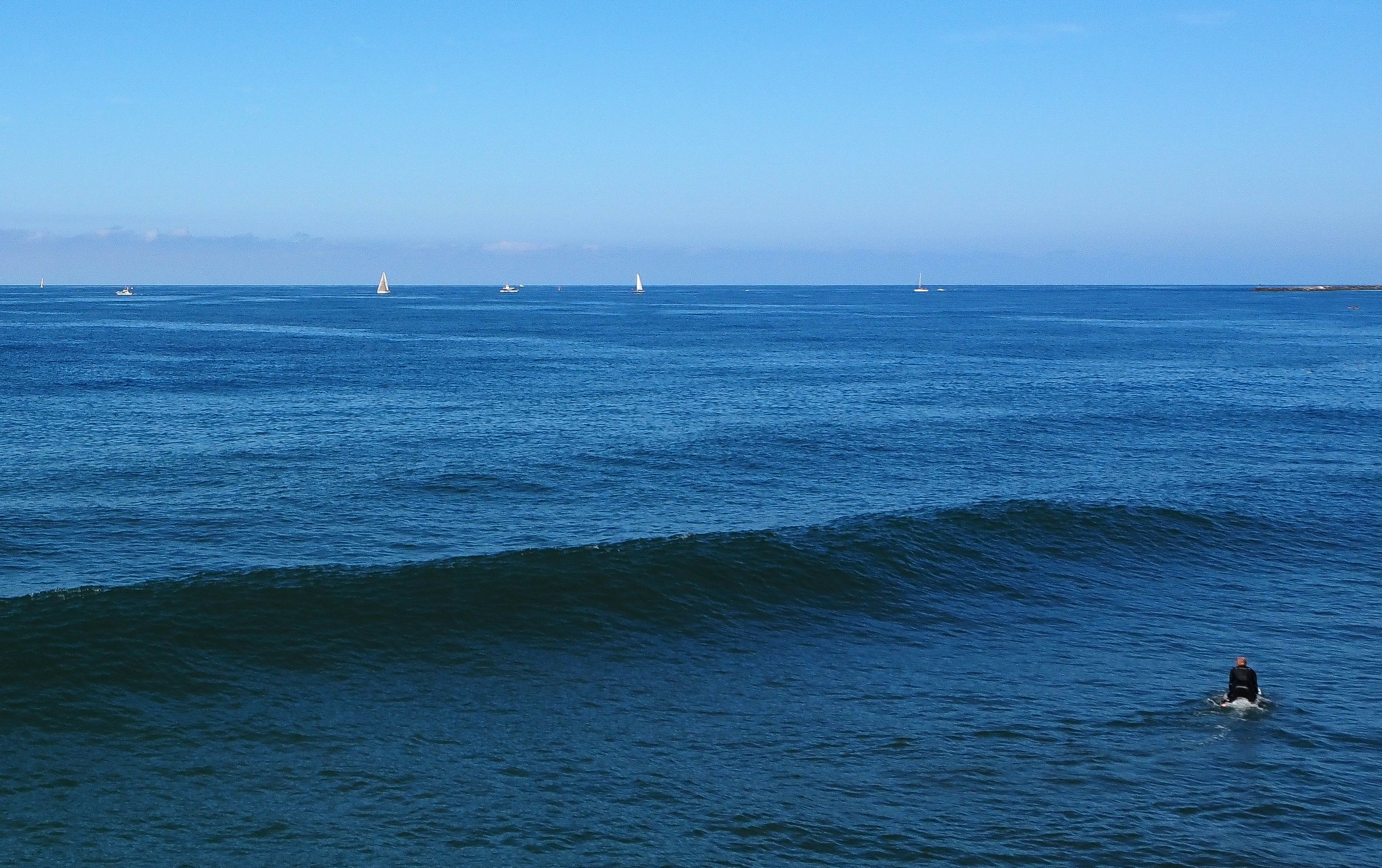 a man riding a wave on top of a surfboard