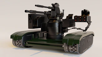 a green and black robot with a camera attached to it