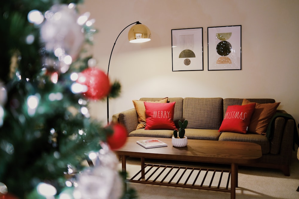 a living room with a couch and a christmas tree