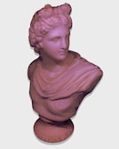 A low-poly 3D rendering of a classical-style bust featuring a figure with curly hair and a draped garment, set against a plain background. The style emphasizes geometric shapes and facets, giving it a modern, artistic interpretation.