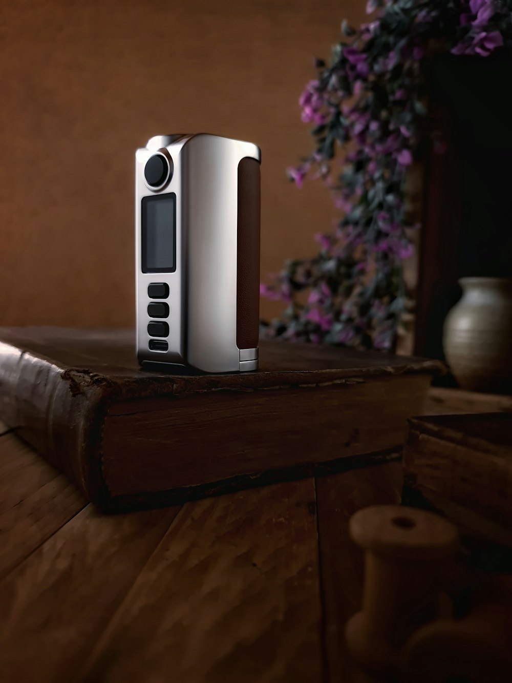 a white electronic device sitting on top of a wooden table