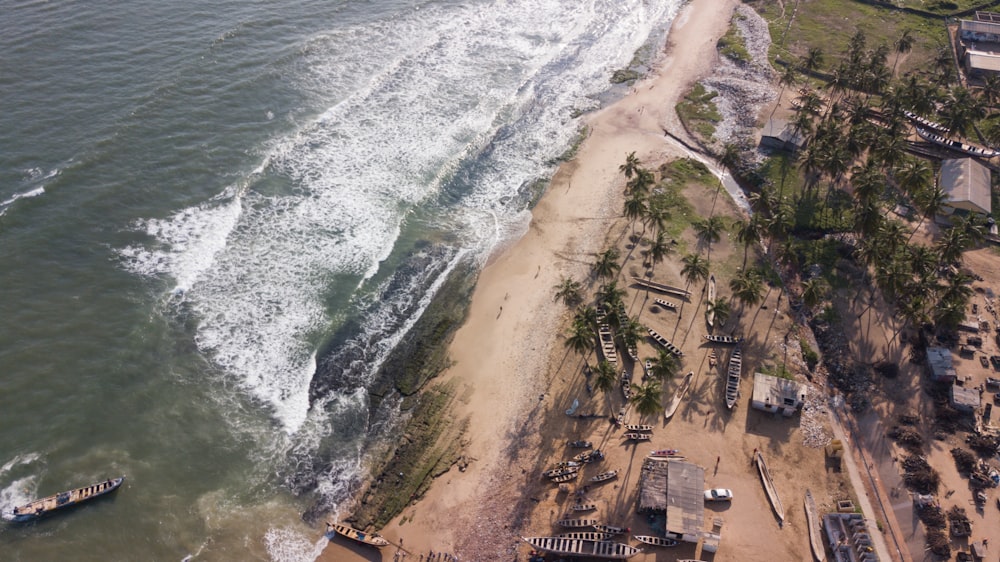 an aerial view of a beach with a boat in the water