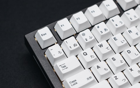 a close up of a keyboard on a black surface