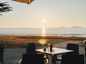 Sunshine Coast beach view visible through the cafe’s large windows during golden hour.